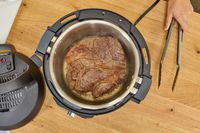 Meat cooks inside the Instant Pot Pro 10-in-1 6-Quart Pressure Cooker