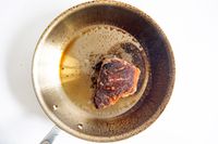 Food cooking in a pan from the All-Clad D3 3-Ply Stainless Steel Cookware Set 10 Piece