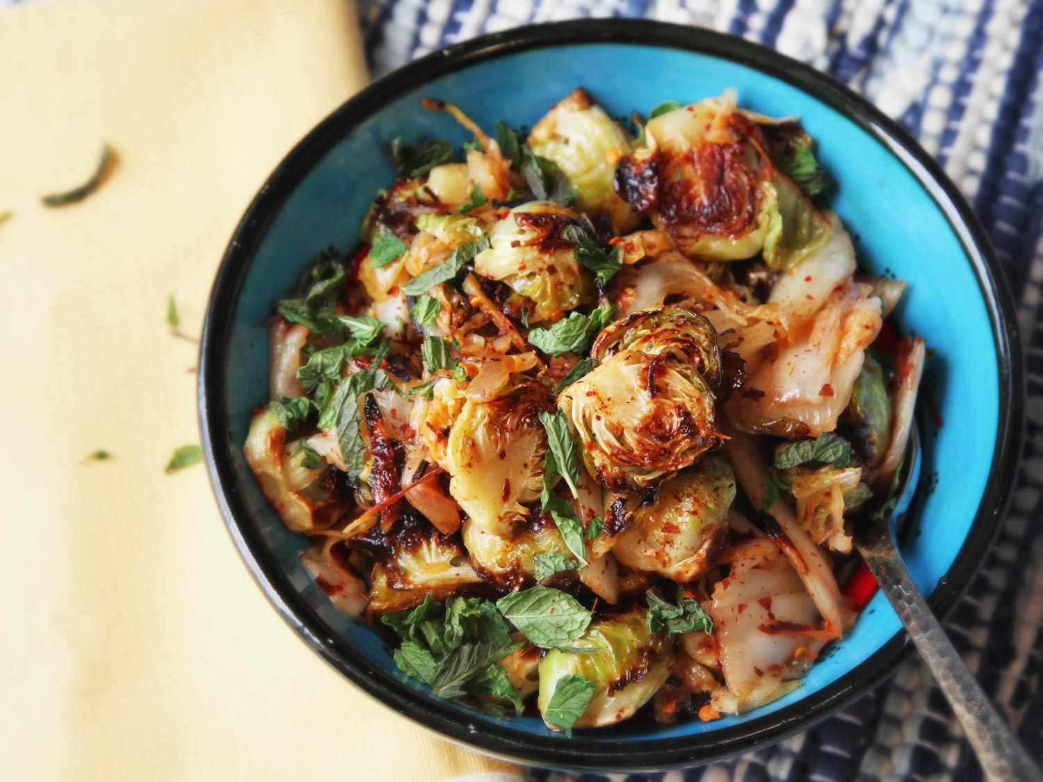 Bowl of Brussels sprouts tossed with kimchi.