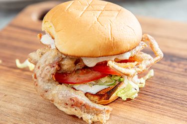 Side view of a fried soft shell crab sandwich