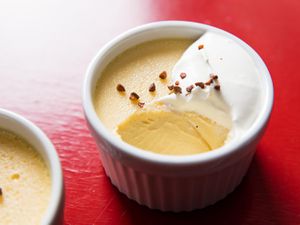A ramekin of roasted buckwheat custard dessert with a spoonful removed.