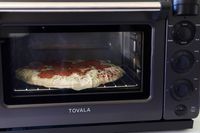 a frozen pizza cooking in the tovala oven