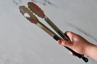 Hand holding the OXO Good Grips 12-Inch Tongs