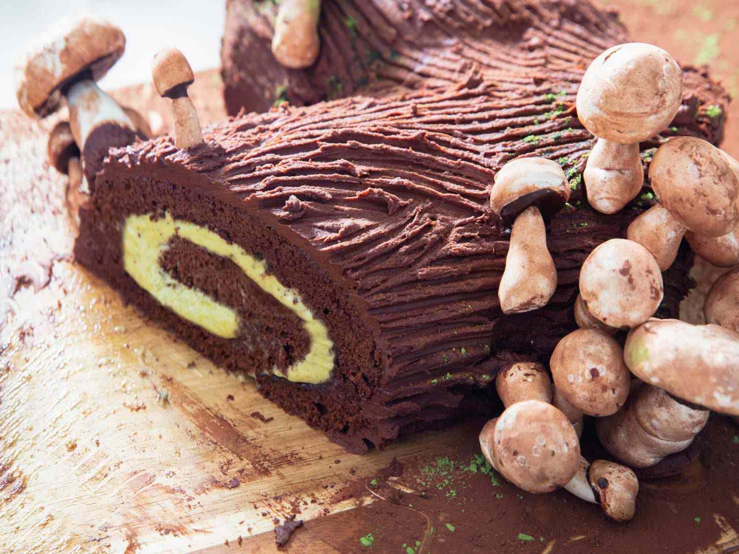 A chocolate and pistachio yule log with meringue mushrooms
