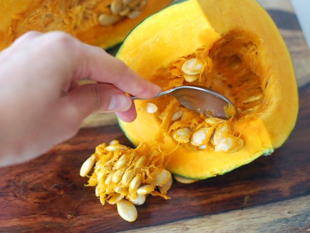 Scooping seeds and innards out of kabocha 