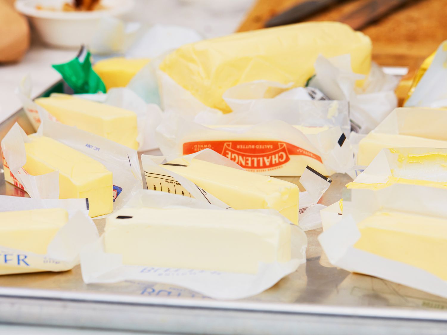 Different butters on a rimmed baking sheet.