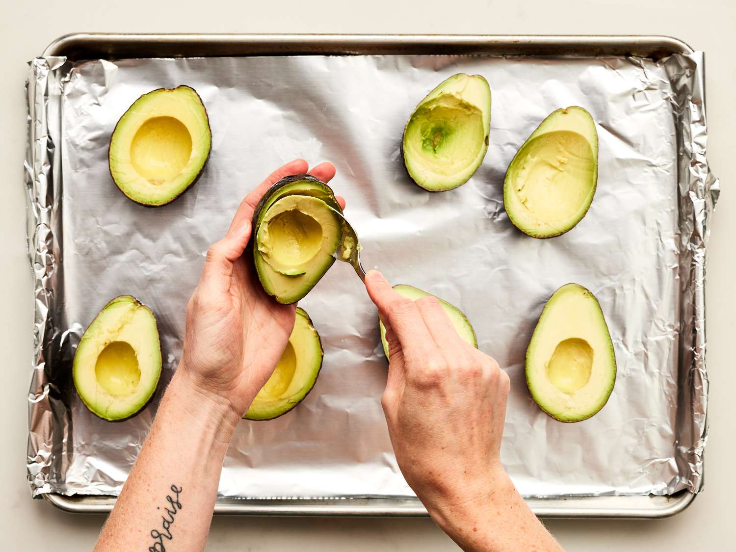 Overhead view of removing middle of the avocado