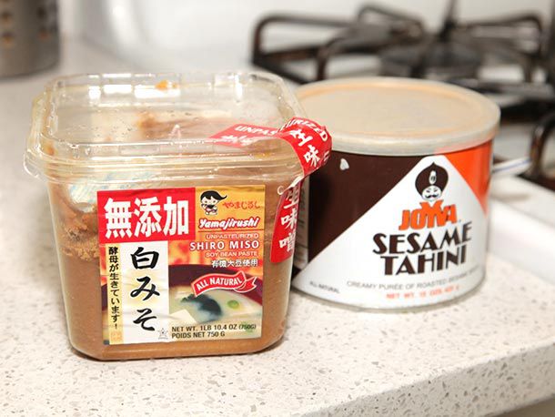 A tub of miso and a tub of tahini. 