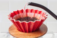 A kettle pouring water into the Origami dripper