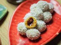 Side angle view of an onde-onde cut in half to show inside