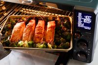 a sheet pan with roasted salmon and broccoli