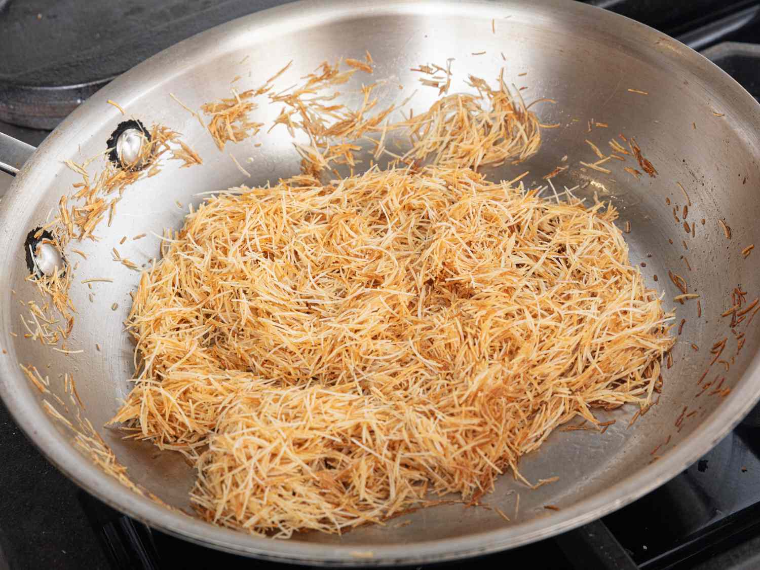 Overhead very of pan frying kataifi pastry