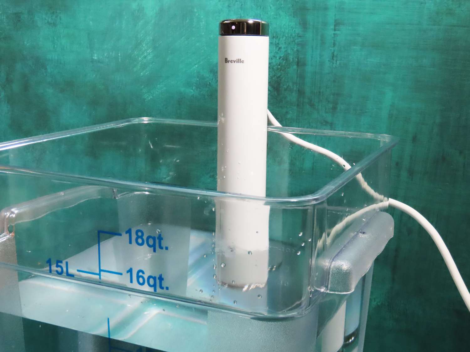 A Breville Joule Turbo sous vide affixed to a plastic Cambro filled with water