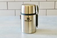 stanley thermos on a blue surface