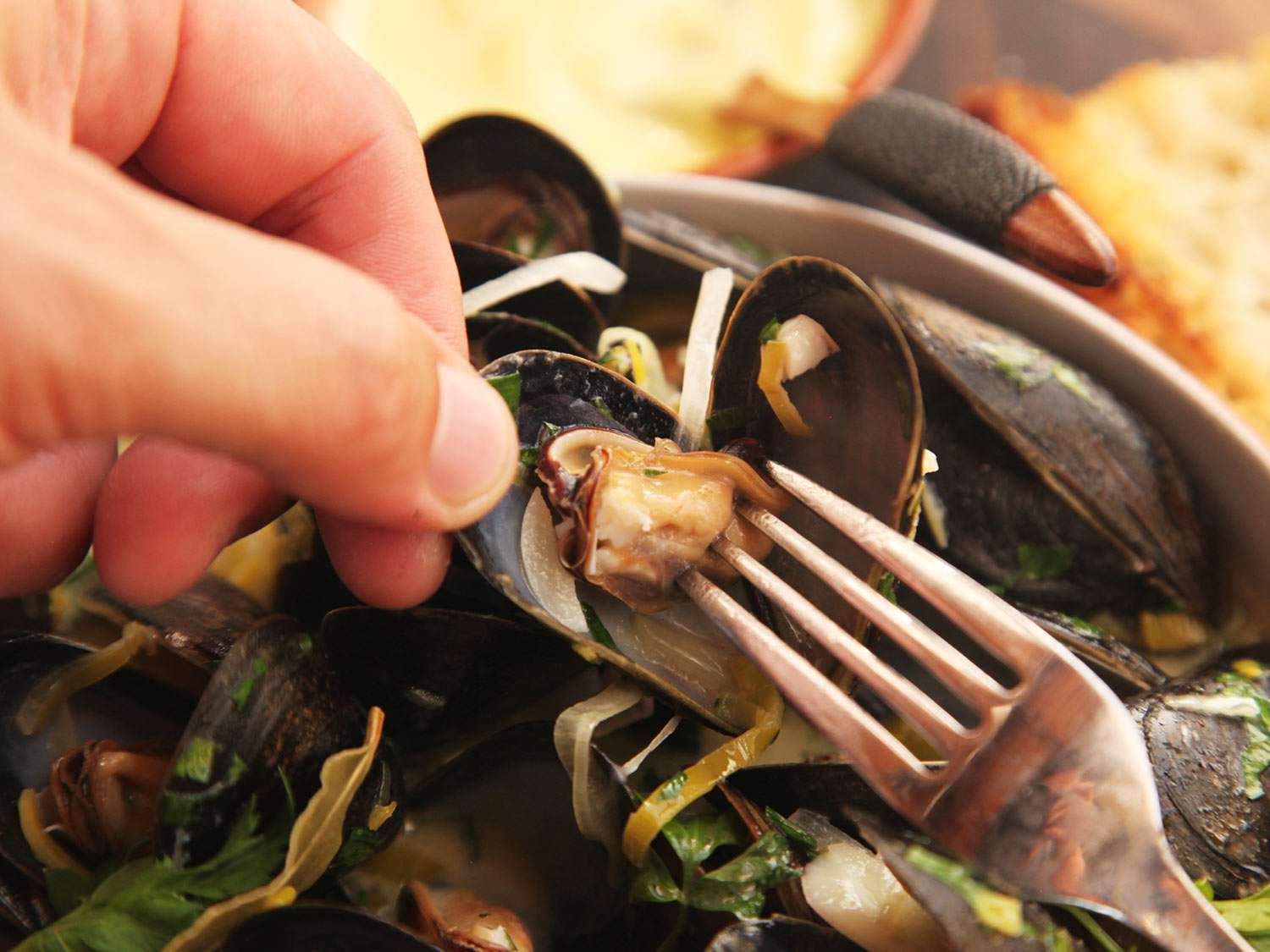Close-up of author spearing mussel meat with his fork.