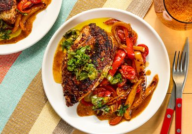 Grilled chicken with sauted vegetables and garnish on a plate