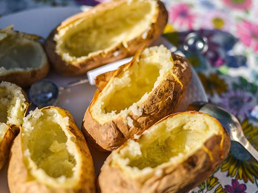 Hollowed out baked potatoes, ready to be baked once more.