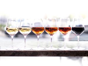 Six wineglasses of sherry, ranging from light to dark