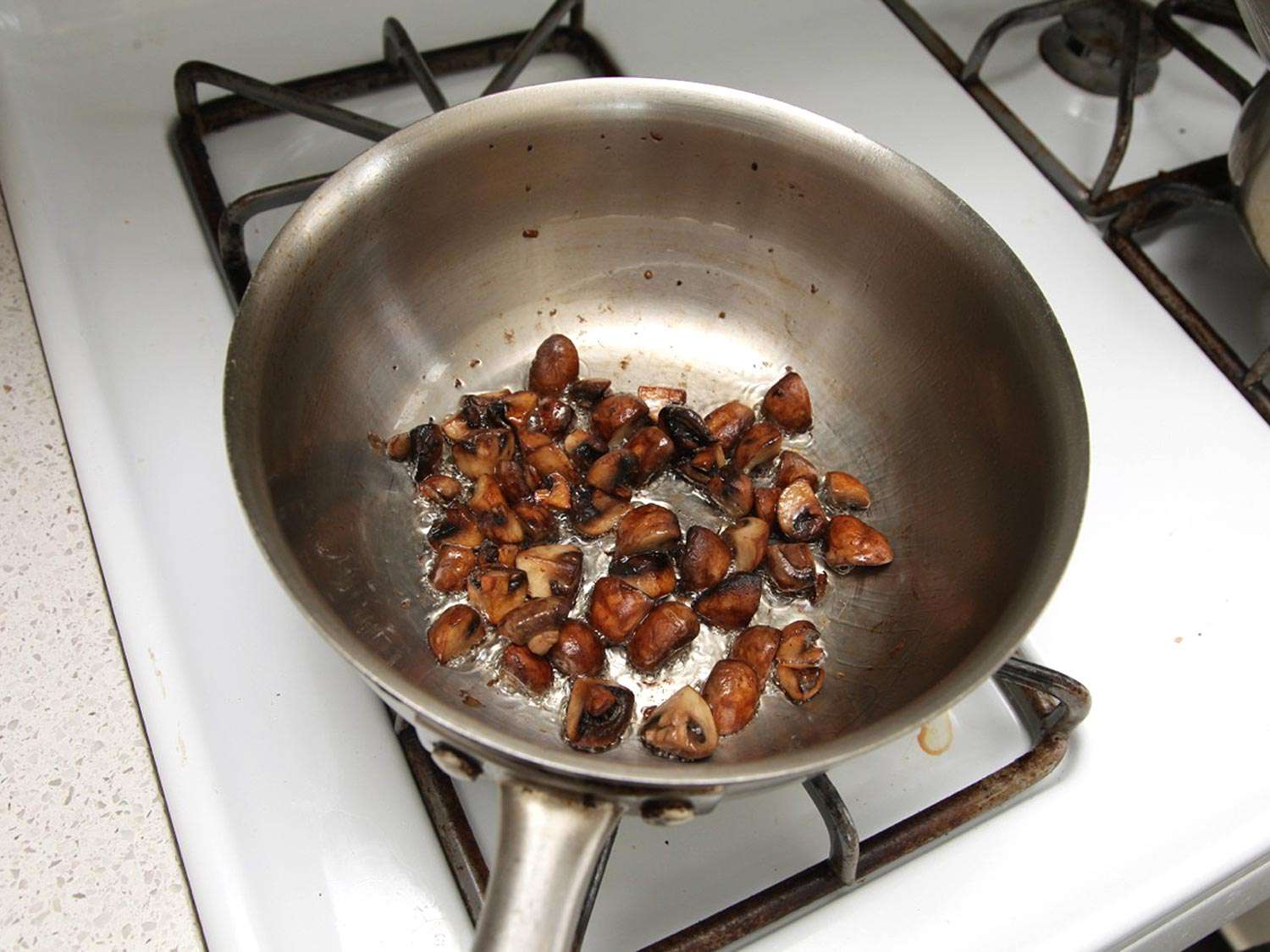 Browning mushrooms in a skillet until deep golden-brown.