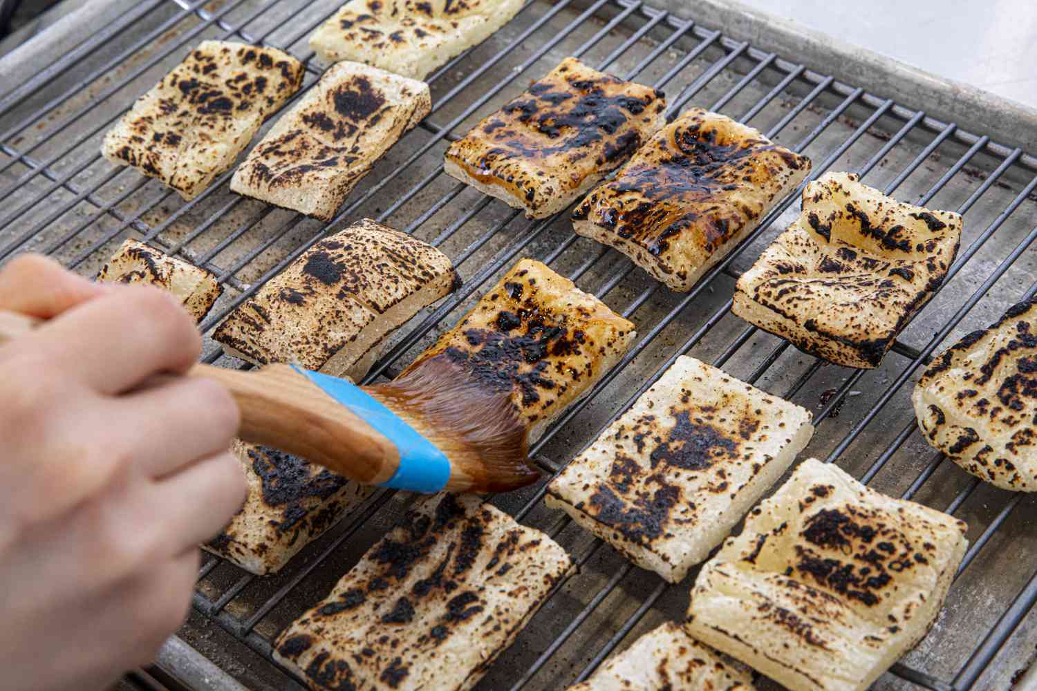 Side angle view of brushing glaze on mochi