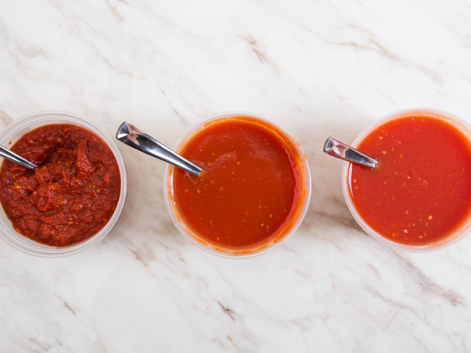 From left to right: Container of fresh tomato paste, container of tomato sauce, container of fresh tomato sauce