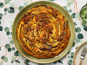 A savory cabbage tart tatin on a green plate