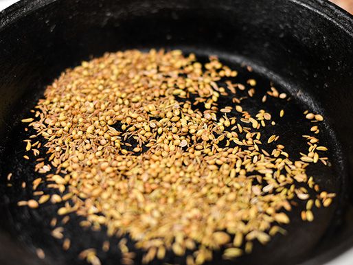Toasting spices in a cast iron skillet.