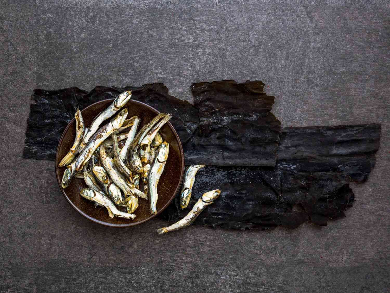 Closeup of dried anchovies and dasima (dried kelp, also known as kombu).