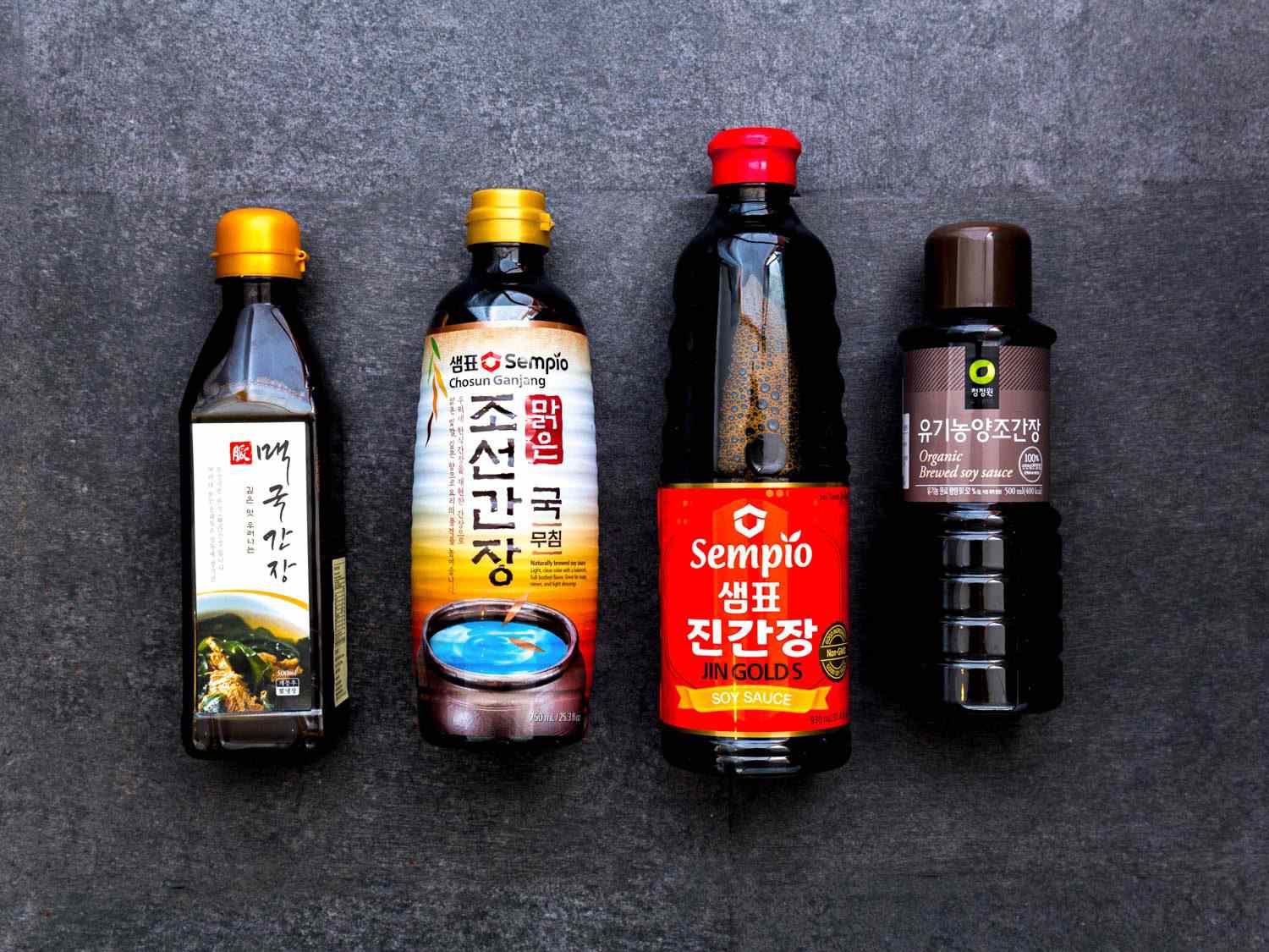 Overhead view of four varieties of ganjang (or Korean soy sauce).