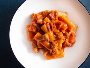 Overhead view of pasta alla zozzona on a white plate
