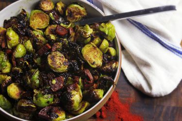 Roasted Brussels Sprouts With Chorizo and Sherry Vinegar, served in a white bowl.
