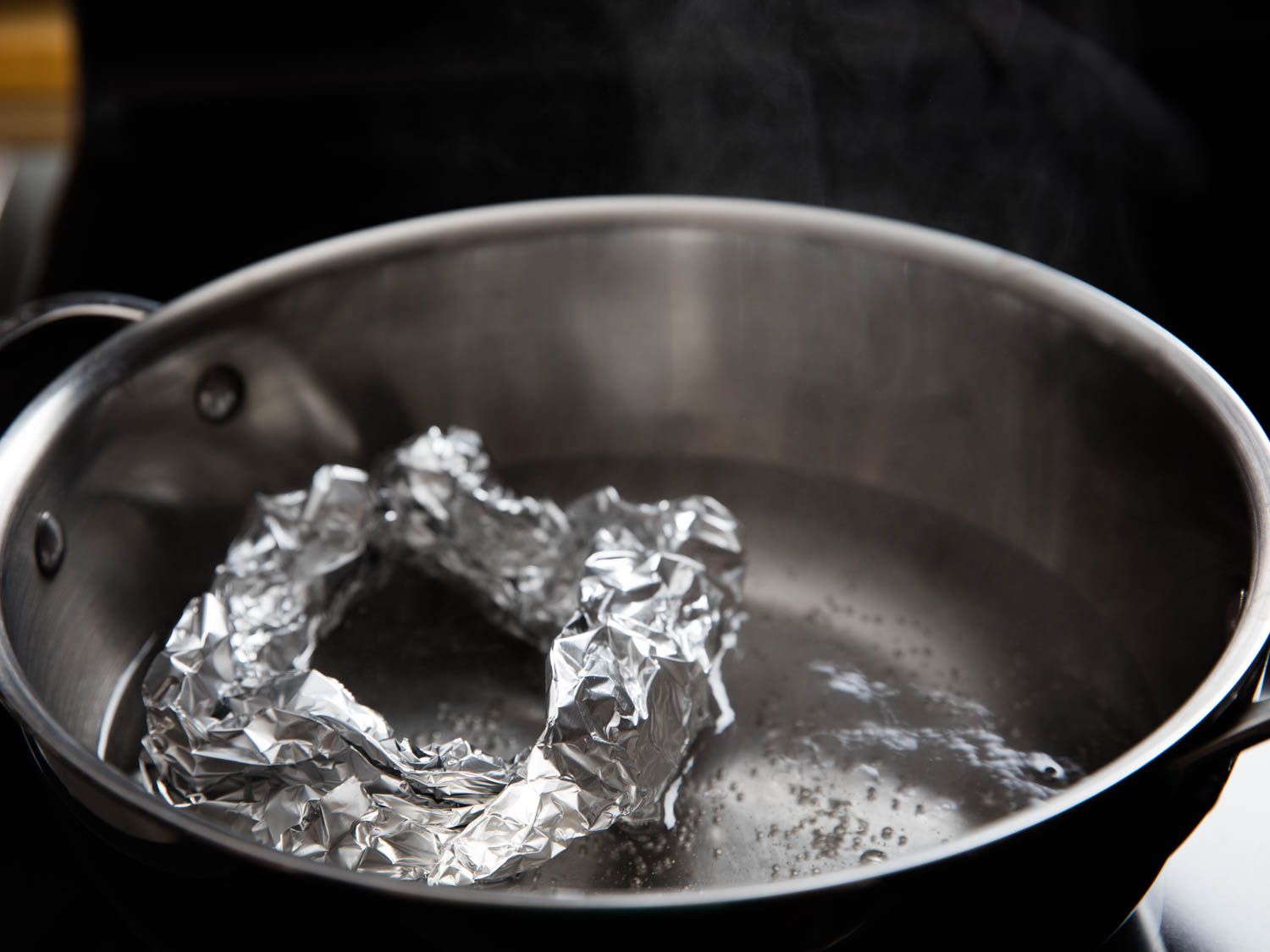 A thick ring of crumpled tin foil on the bottom of simmering pot of water