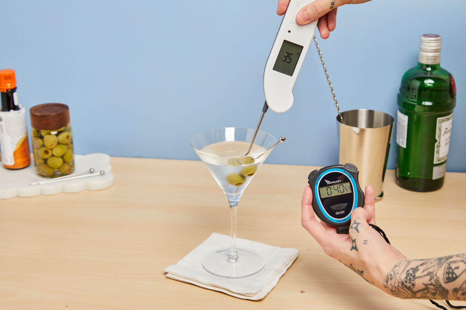 Person checking temperature of liquid in Williams Sonoma Reserve Martini Glasses
