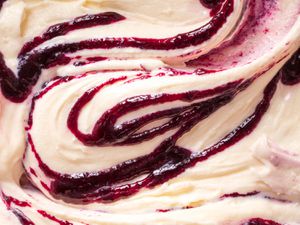 Close-up of ice cream swirled with thick fruit syrup
