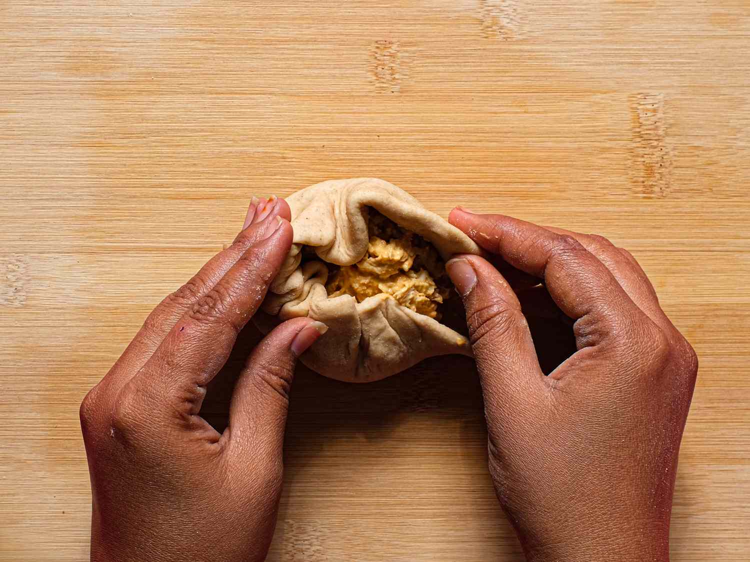 Overhead view of folding dough around filling