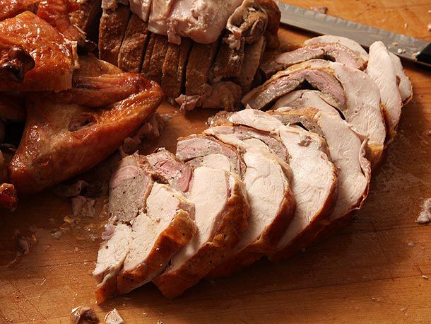 Shingled slices of turducken on cutting board