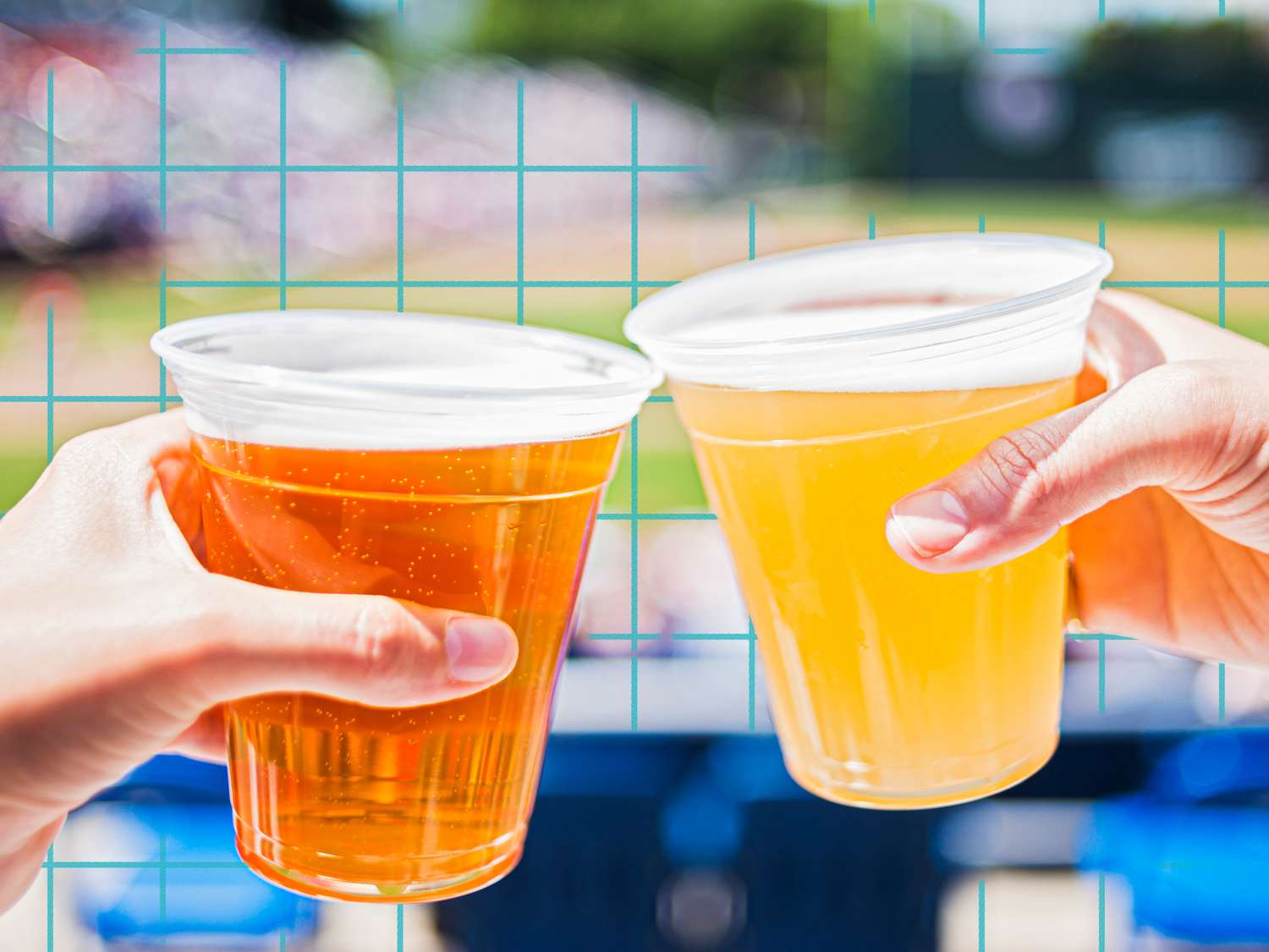 Two hands holding plastic cups of beer in a sports game setting
