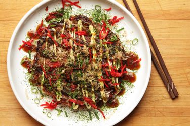 Okonomiyaki (Japanese Cabbage Pancake) on a white plate