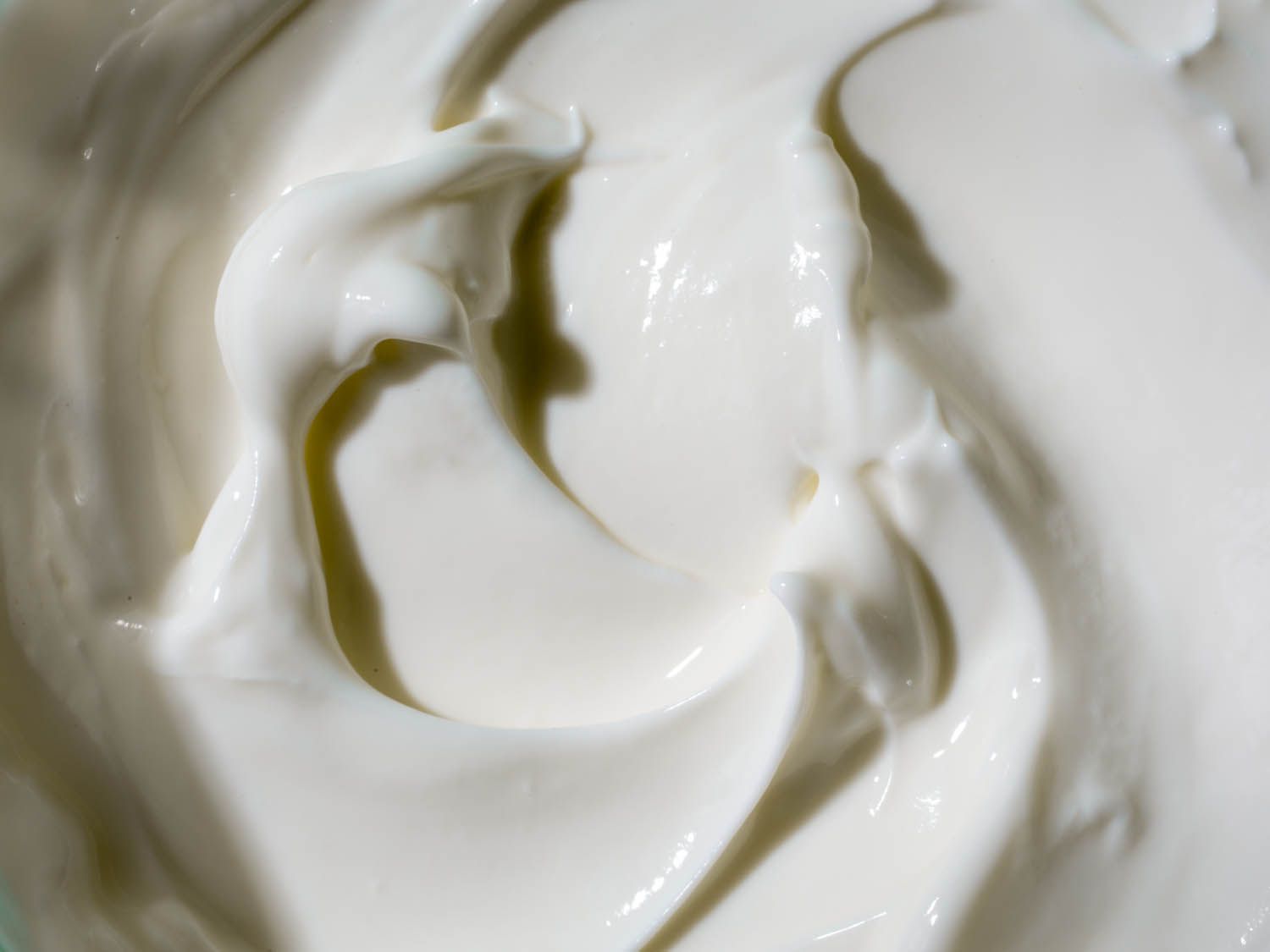Close up view of swirls of Greek yogurt.