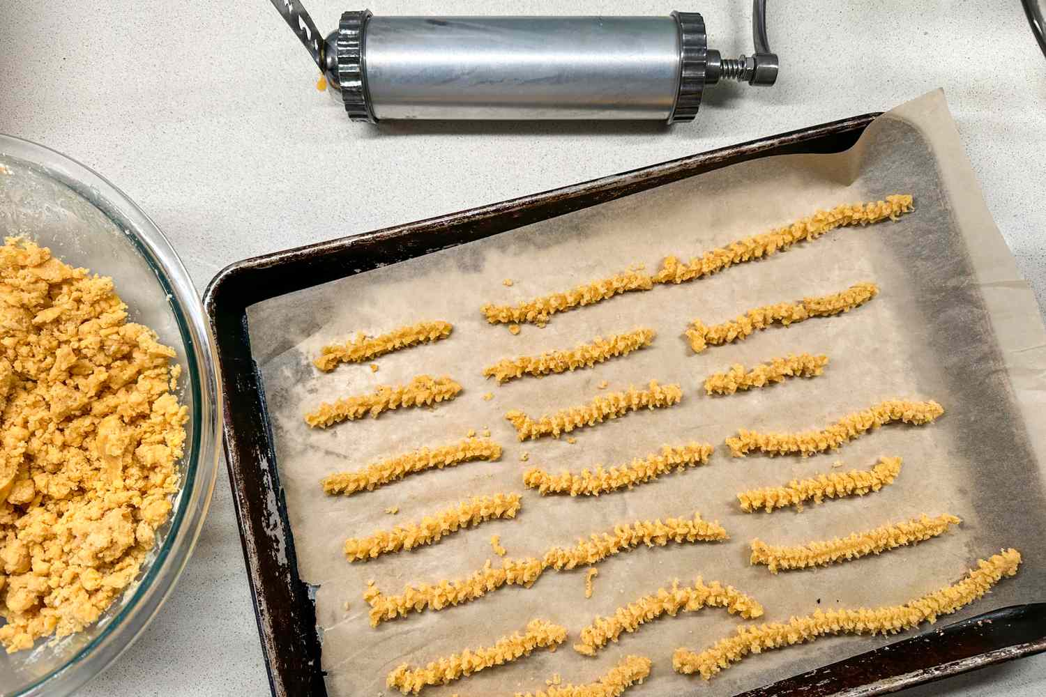 The Fante’s Easy Cookie Press next to a tray of cheese straws