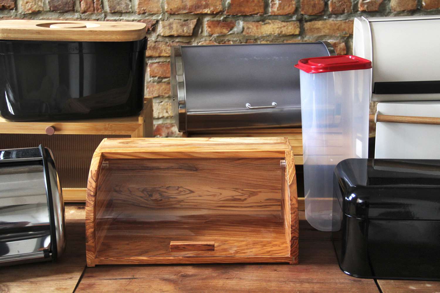 Various bread boxes on a wooden countertop.