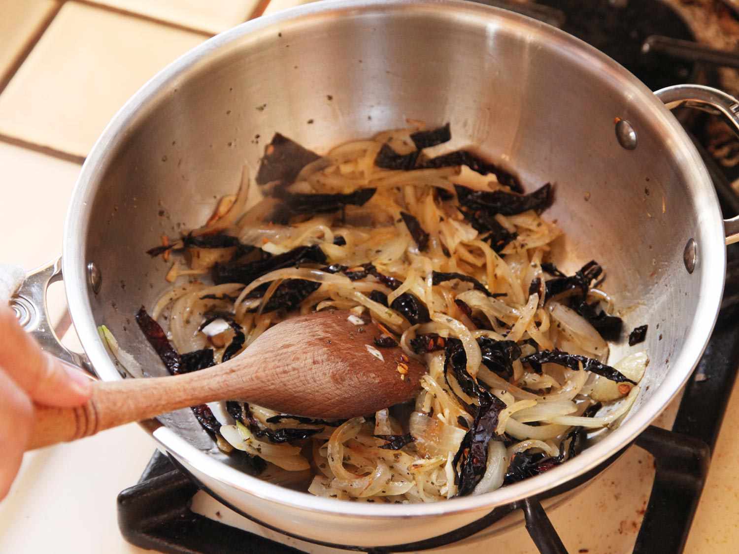 Sauteeing strips of dried chiles, onion, and garlic for huevos rancheros.