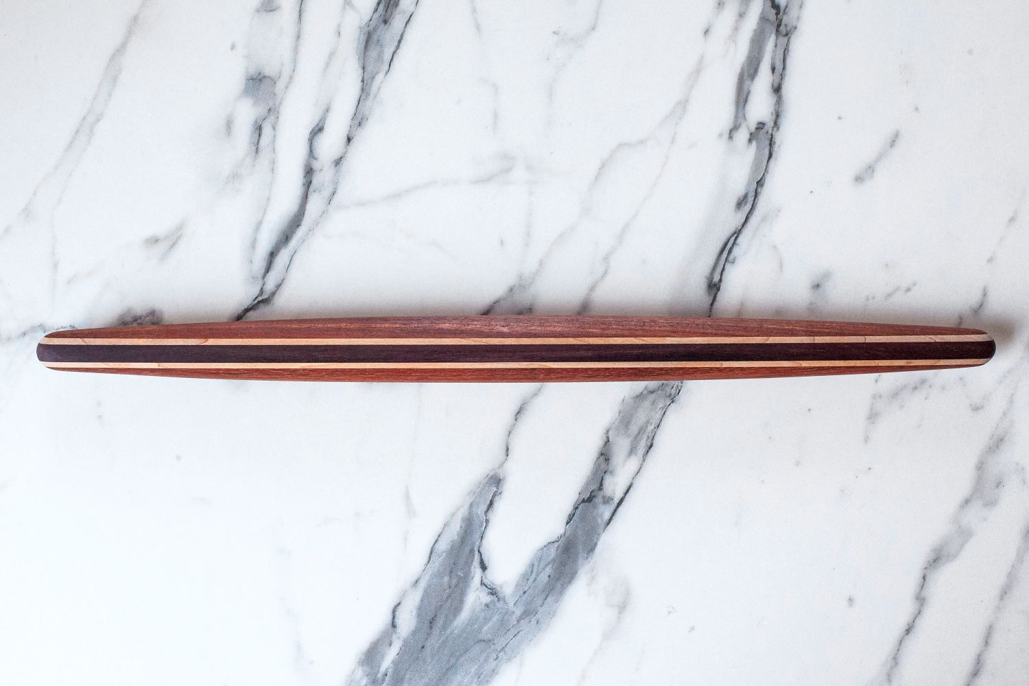 Earlywood French Rolling Pin on a marble surface