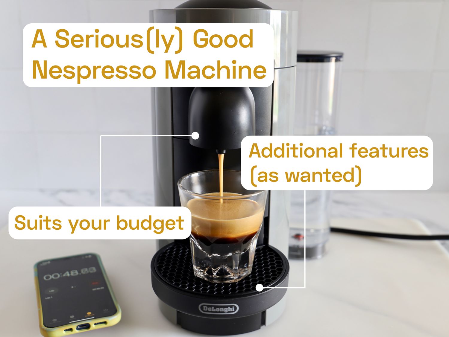 A Nespresso machine brewing coffee into a clear, glass mug.