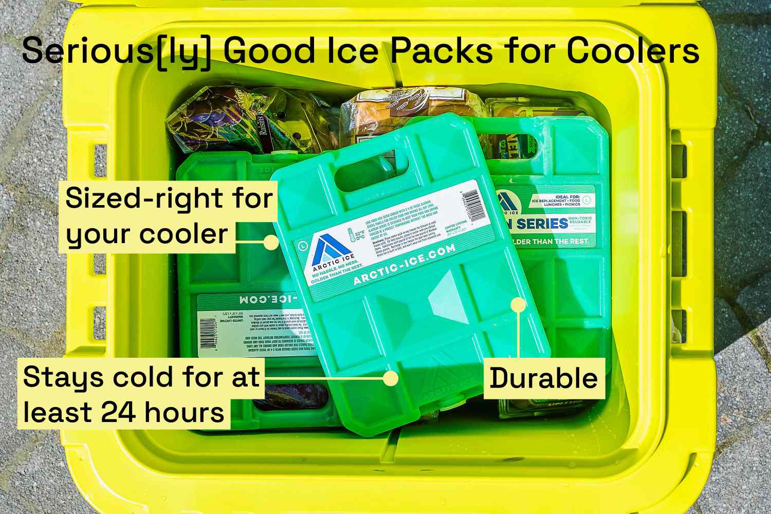 Three hard ice packs in a bright yellow cooler on a patio
