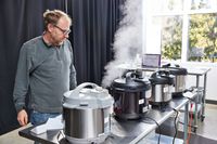 Instant Pot Duo Plus 8-Quart Multi-Use Pressure Cooker V4 lined up next to other pressure cookers