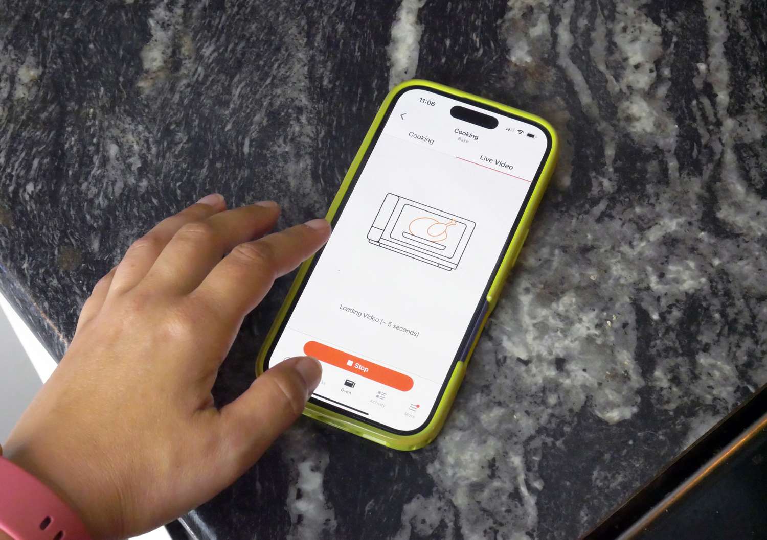 a person with a phone displaying the anova app