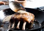 Spooning butter on a pan-roasted rack of lamb. 