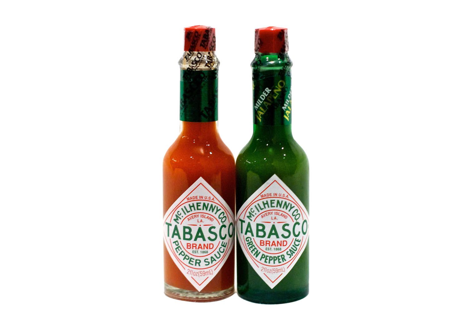 Two bottles of Tabasco pepper sauce; one is traditional and one is green pepper sauce.