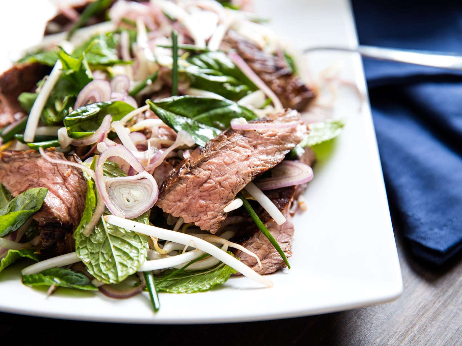 A plate of Thai-style marinated flank steak and herb salad